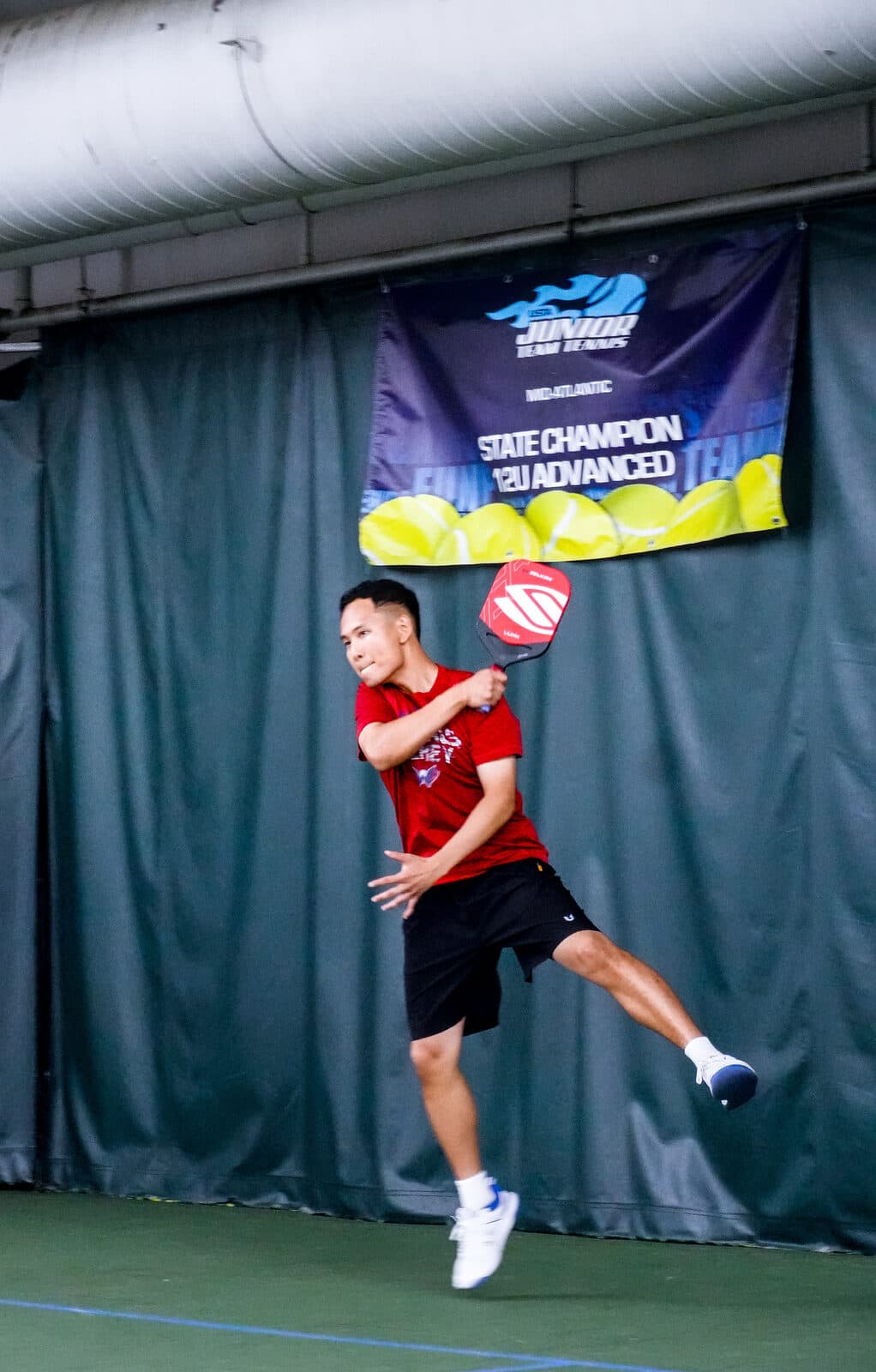 Midsummer Madness — a player leaps to attack an overhead